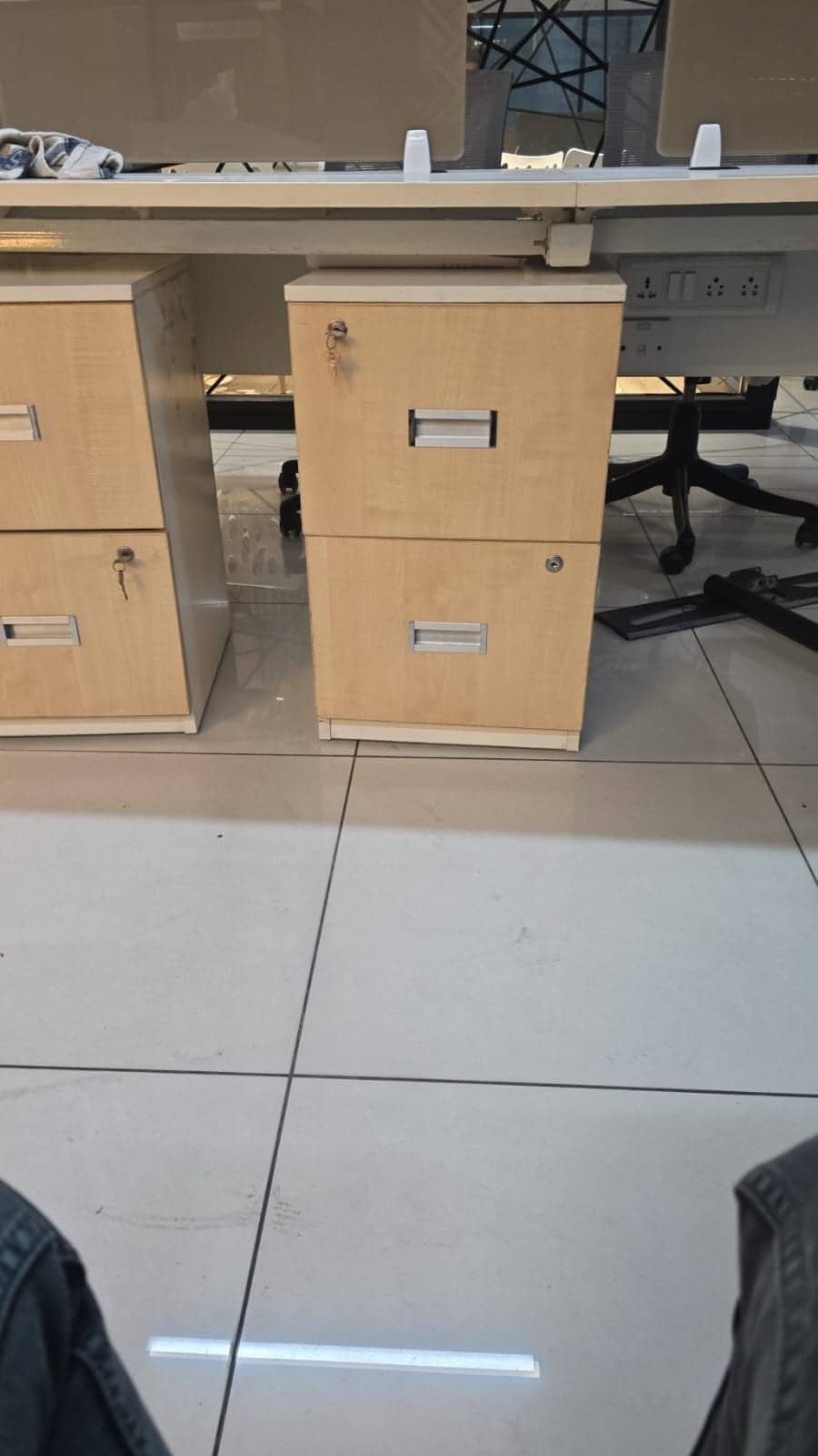 Wooden office pedestals beside workstations