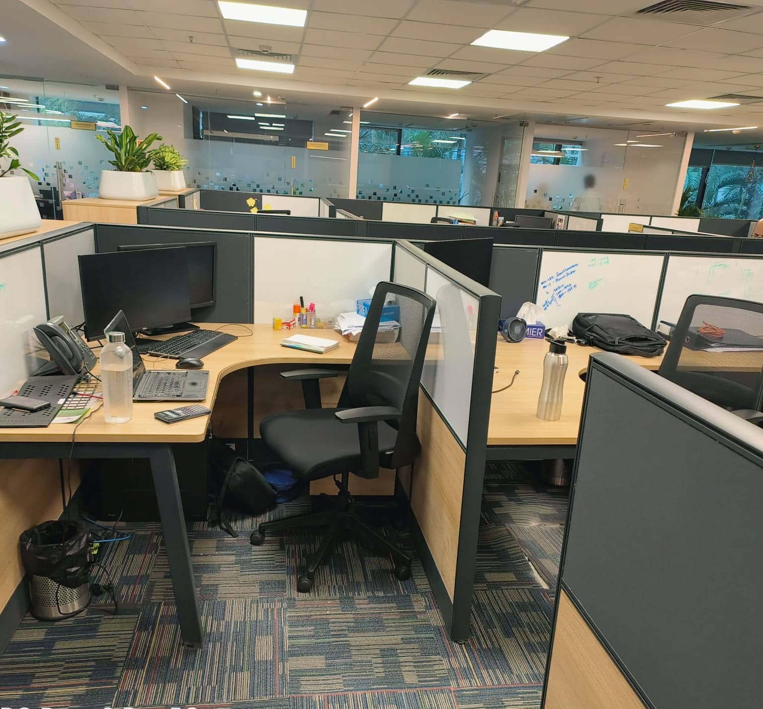 Open-plan office with workstations, chairs and partitions